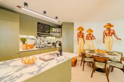 a kitchen with two mannequins on the wall at Apt-Casa Marina Cruz Bay View-10 mins walk Oldtown in Cartagena de Indias