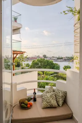 a balcony with a table with fruits and a bottle of wine at Apt-Casa Marina Cruz Bay View-10 mins walk Oldtown in Cartagena de Indias