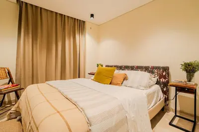 a bedroom with a bed with yellow pillows on it at Apt-Casa Marina Cruz Bay View-10 mins walk Oldtown in Cartagena de Indias