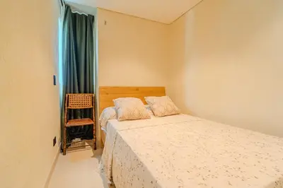 a small bedroom with a bed and a window at Apt-Casa Marina Cruz Bay View-10 mins walk Oldtown in Cartagena de Indias
