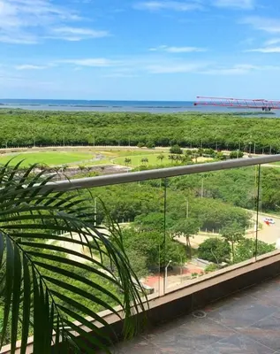 a balcony with a view of a park and the ocean at Apt 3 Bedrooms SeaView AC Buenavista in Puerto Colombia
