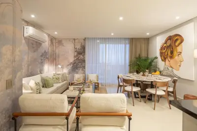 a living room with a couch and a dining room at Apt 3 Bedrooms SeaView AC Buenavista in Puerto Colombia
