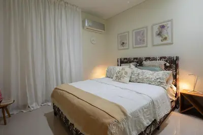 a bedroom with a large bed with white sheets and pillows at Apt 3 Bedrooms SeaView AC Buenavista in Puerto Colombia