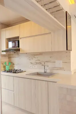 a kitchen with wooden cabinets and a sink at Apartamento frente al mar in San Silvestre