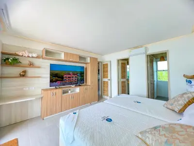 a bedroom with a bed and a flat screen tv at Apartamento frente al mar in San Silvestre