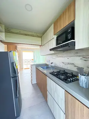 a kitchen with a refrigerator and a stove top oven at Apartamento frente al mar in San Silvestre