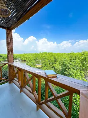 a wooden deck with a glass of wine and a book at Apartamento frente al mar in San Silvestre