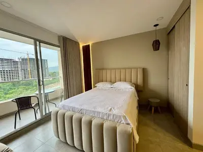 a bedroom with a large bed and a large window at Apartamento cerca del mar- SantaMarina-604 in Santa Marta