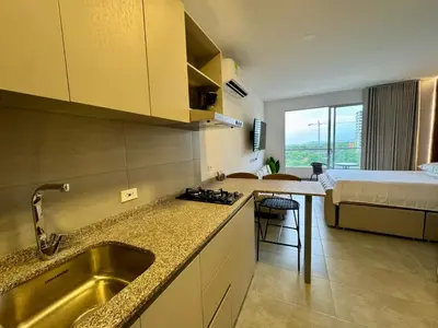 a kitchen with a sink and a bed in a room at Apartamento cerca del mar- SantaMarina-604 in Santa Marta