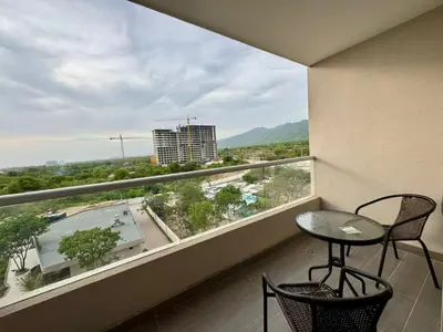 a balcony with a table and chairs and a large window at Apartamento cerca del mar- SantaMarina-604 in Santa Marta