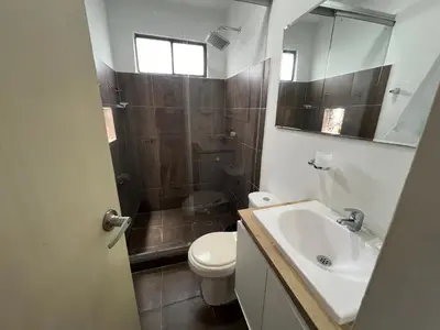 a bathroom with a toilet and a sink and a shower at Vistas del Mar in Barranquilla