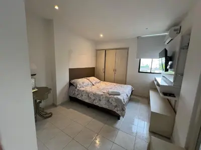 a small bedroom with a bed and a sink at Vistas del Mar in Barranquilla