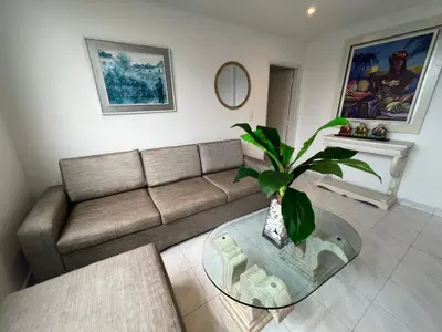 a living room with a couch and a glass table at Vistas del Mar in Barranquilla