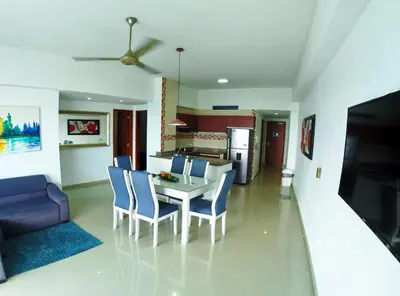 a kitchen and living room with a table and chairs at Big in Cartagena de Indias