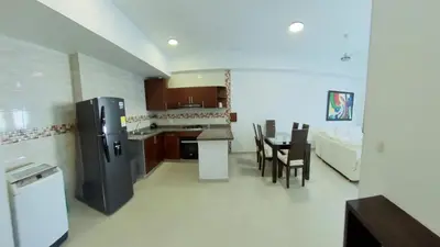a kitchen and dining room with a refrigerator and a table at Big in Cartagena de Indias