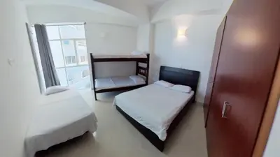 a small room with two beds and a window at Big in Cartagena de Indias