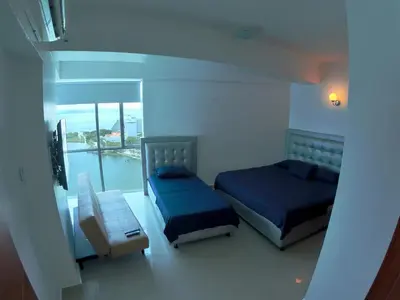 a bedroom with two beds and a balcony at Big in Cartagena de Indias