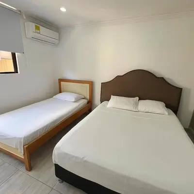 two beds in a small room with two beds sidx sidx sidx at Riomar in Barranquilla