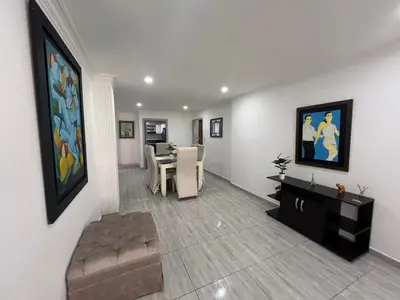 a living room with a couch and a dining room at Riomar in Barranquilla