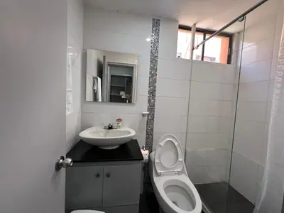 a small bathroom with a toilet and a sink at Riomar in Barranquilla