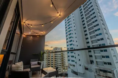 a balcony with chairs and a view of a building at Murano Centro/Nuevo, Moderno/Vista al Mar /Piscina in Cartagena de Indias