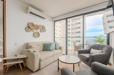 a living room with a couch and a chair at Murano Centro/Nuevo, Moderno/Vista al Mar /Piscina in Cartagena de Indias