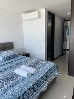 a bedroom with a bed with towels on it at Eliptic Cartagena-Oceano in Cartagena de Indias