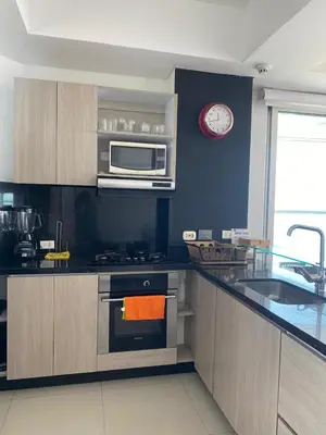 a kitchen with a stove and a clock on the wall at Eliptic Cartagena-Oceano in Cartagena de Indias