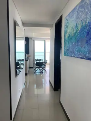 a hallway with a painting on the wall and a dining room at Eliptic Cartagena-Oceano in Cartagena de Indias