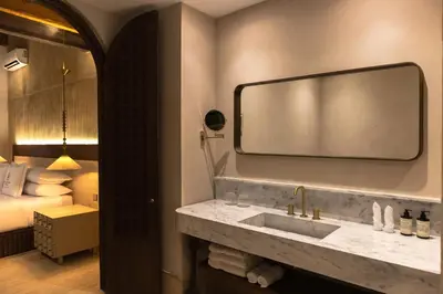 a bathroom with a sink with a large mirror at Hotel Palacio del Agua by Faranda Boutique in Cartagena de Indias
