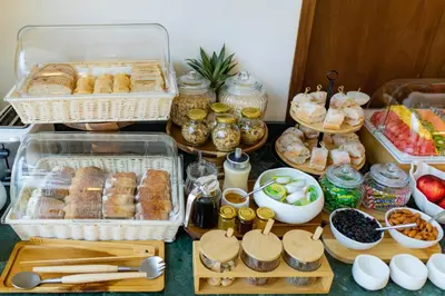 a table topped with baskets of pastries and other foods at Hotel Palacio del Agua by Faranda Boutique in Cartagena de Indias