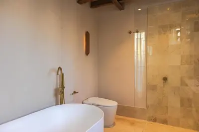 a bathroom with a shower and a toilet and a tub at Hotel Palacio del Agua by Faranda Boutique in Cartagena de Indias
