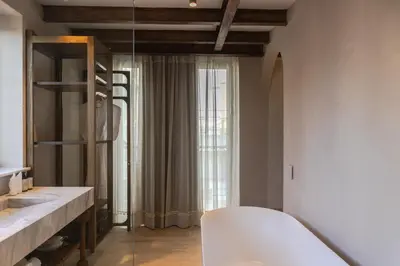 a bathroom with a white tub and a window at Hotel Palacio del Agua by Faranda Boutique in Cartagena de Indias