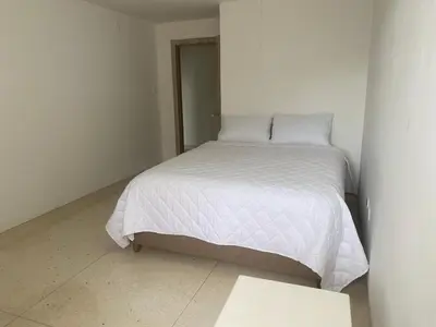 a small bedroom with a white bed in a room at Your ideal stay in Barranquilla awaits