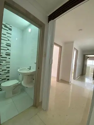 a white bathroom with a toilet and a sink at Your ideal stay in Barranquilla awaits