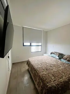 a bedroom with a bed and a window in it at New and Modern Loft in exclusive northern area in Barranquilla