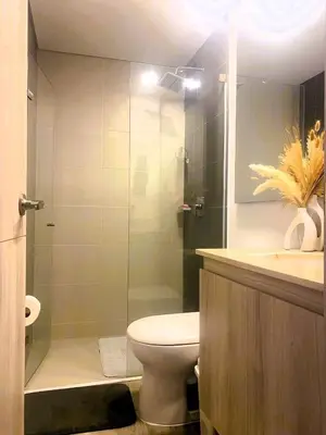a bathroom with a toilet and a glass shower at New and Modern Loft in exclusive northern area in Barranquilla