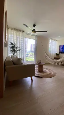 a living room with a couch and a hammock at Minimalist and cozy apartment in Barranquilla