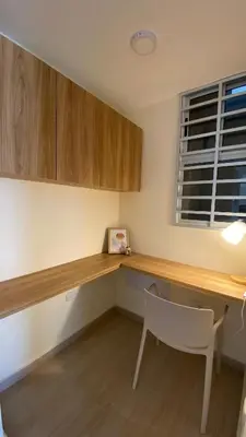 a kitchen with a desk and a chair and a window at Minimalist and cozy apartment in Barranquilla