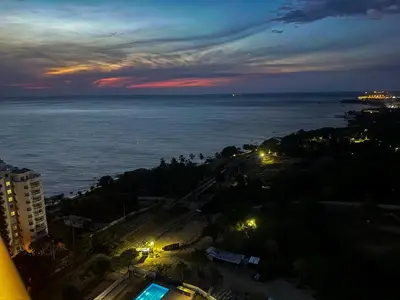 a view of the ocean at night from a building at Apartment on the 21st floor, ocean and Sierra views in Simón Bolivar