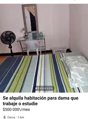 a bedroom with a bed and a table with a table at Hostal Mr Key in Barranquilla