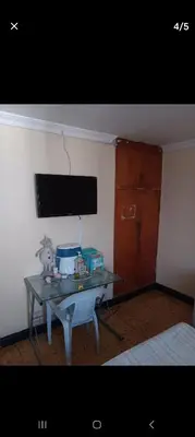a small table in a room with a table with a table at Hostal Mr Key in Barranquilla