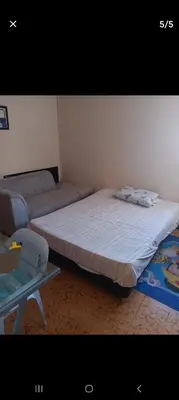 a bedroom with two beds and a table in it at Hostal Mr Key in Barranquilla