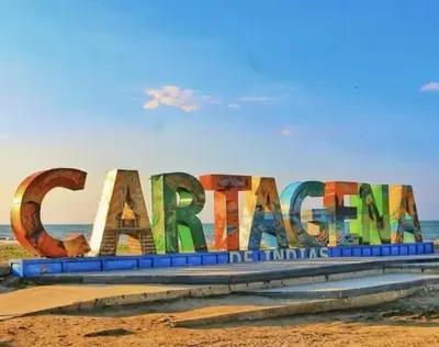 a large sign on a beach with the ocean in the background at Apartamento cerca a playas de marbella in Cartagena de Indias