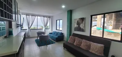 a living room with a couch and a table at Live Stay - Boquilla SunSet in Cartagena de Indias