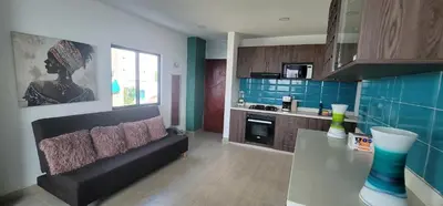 a kitchen with a couch and a table in a room at Live Stay - Boquilla SunSet in Cartagena de Indias