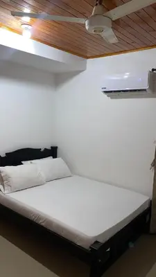 a white bed in a room with a ceiling at GUILLOTE Comfort Loft in Cartagena de Indias