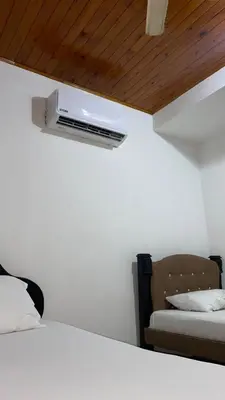 a room with two beds and a air conditioner on the wall at GUILLOTE Comfort Loft in Cartagena de Indias