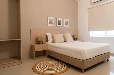 a bedroom with a large bed and a rug at Hotel Casa Obed in Cartagena de Indias