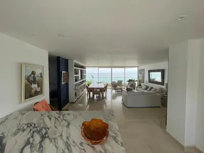 a bedroom with a bed and a living room at Oceanfront Oasis in Cartagena de Indias
